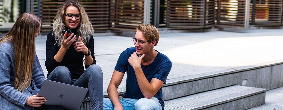 Group of friends collaborating outdoors