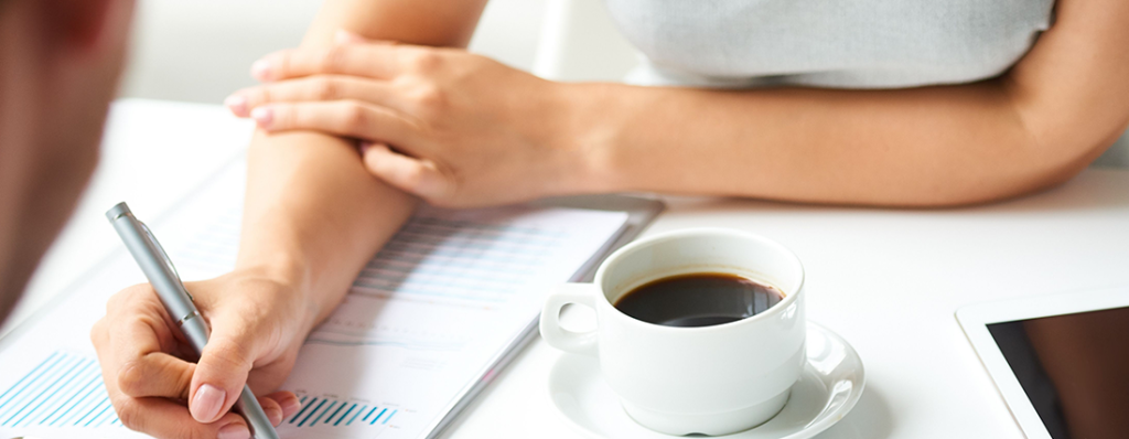 Hands, coffee cup, document table